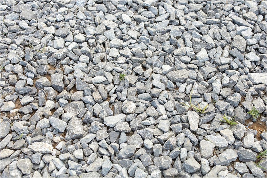 gray and white rocks with the brown dirt and a few green cuts of grass showing through.  Kimberly Martindale Photography uses this image to help clients see how nature shows colors that go together