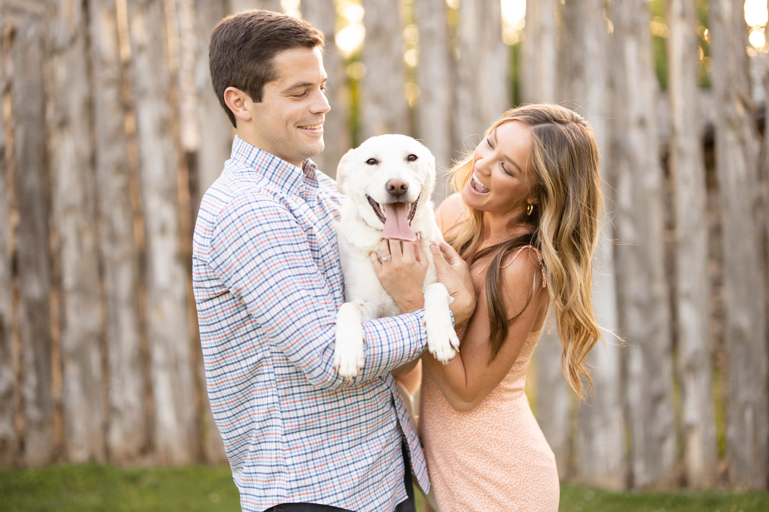 couple holding dog that is looking directly at camera Kimberly Martindale Photography